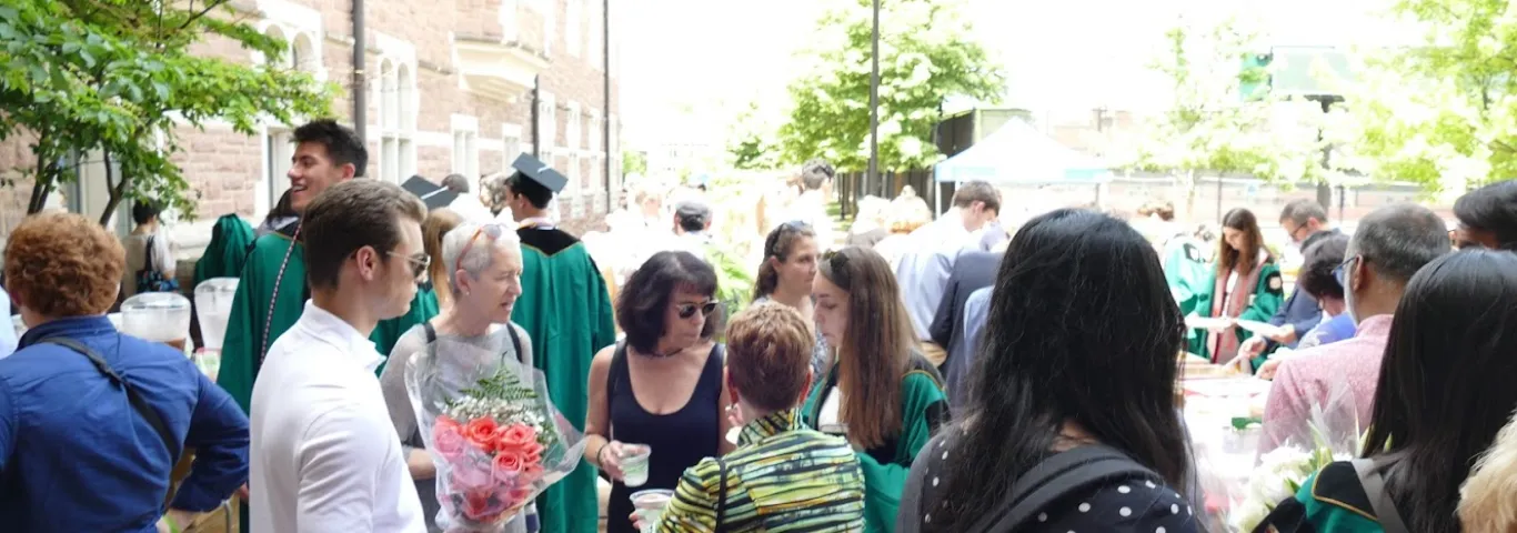 students and faculty mingle in the courtyard outside Seigle Hall